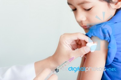 Boy And Vaccine Syringe Stock Photo