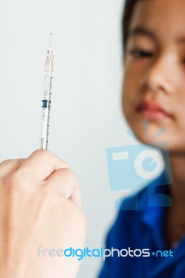 Boy And Vaccine Syringe Stock Photo