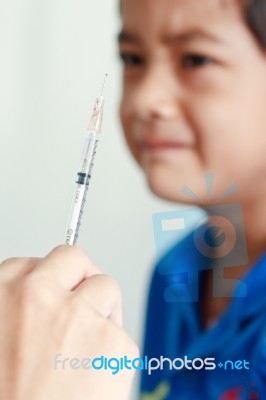 Boy And Vaccine Syringe Stock Photo