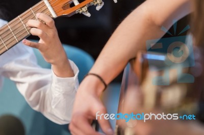 Boy And Woman Playing Guitar Stock Photo