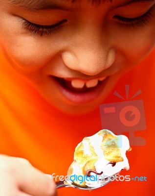 Boy Eating Creamy Puff Stock Photo