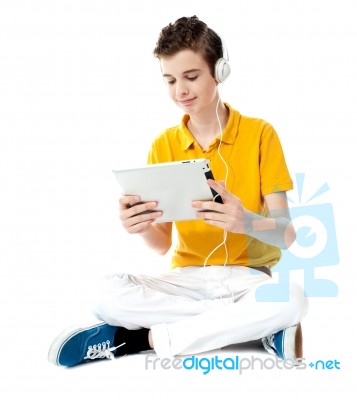 Boy Listening Music With Tablet Pc Stock Photo