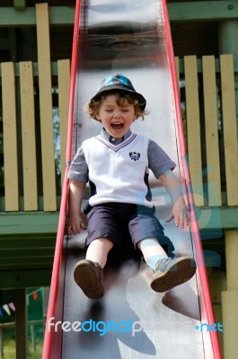 Boy On A Slide Having Fun Stock Photo