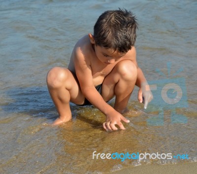 Boy On The Beach Stock Photo