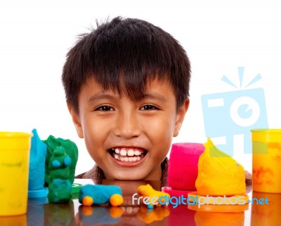 Boy Playing With Colored Dough Stock Photo