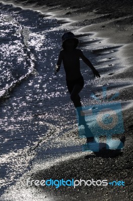 Boy Running On A Beach Stock Photo