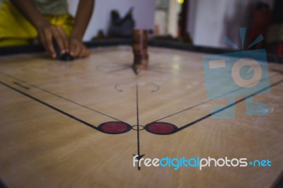 Boy Setting Up A Carroms Board Stock Photo