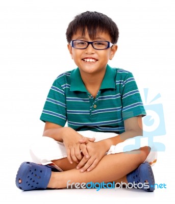 Boy Sitting On Floor Stock Photo