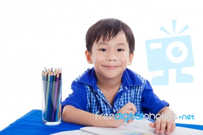 Boy Smiling And Drawing Stock Photo