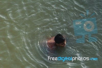 Boy Swimming In The Bharatha River Stock Photo