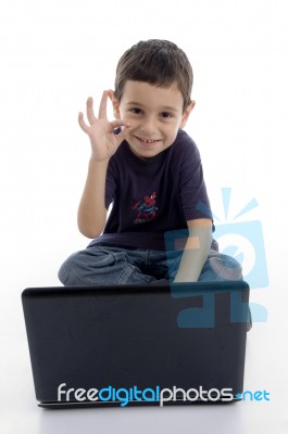 Boy With Laptop Showing Ok Gesture Stock Photo