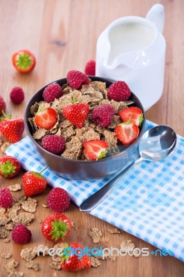 Bran Flakes With Fresh Raspberries And Strawberries And Pitcher Stock Photo