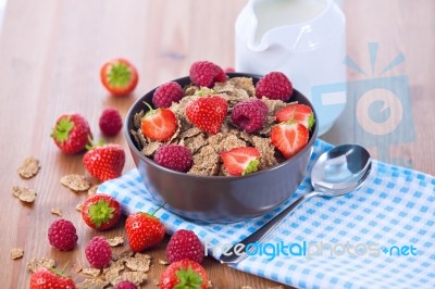 Bran Flakes With Fresh Raspberries And Strawberries And Pitcher Stock Photo