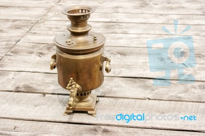 Brass Samovar On A Wooden Table Stock Photo