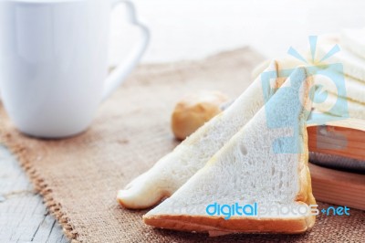 Bread And Cup On Table Stock Photo