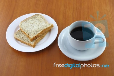 Bread Dish And Coffee On Wooden Table Stock Photo