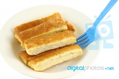 Bread Stick In White Disk With Blue Plastic Fork Dip Stock Photo