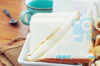 Breads And Cup On Wooden Stock Photo