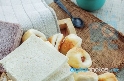 Breads And Cup On Wooden Floor Stock Photo