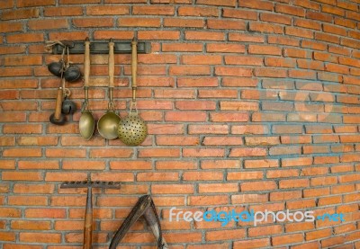 Brick Wall With A Spade And Ladle Hanging Stock Photo