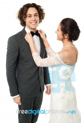 Bride Adjusting Her Man's Bow Tie Stock Photo