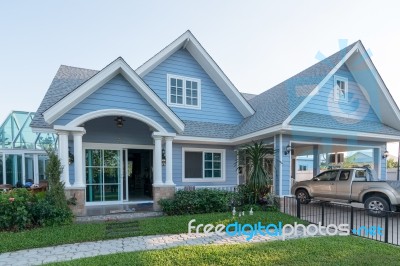 Bright Blue House In Sunlght With Colorful Poppies And Some Grac… Stock Photo