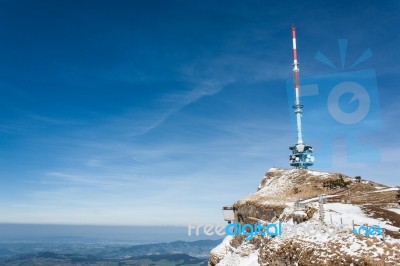 Broadcast / Radio Mast On The Top Of The Mountain Rigi With A Mountain Rail And A Blue Background Stock Photo