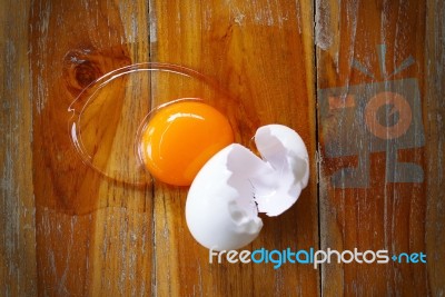 Broken Egg On Wooden Table Background Stock Photo