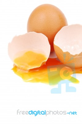 Broken Egg With The Yolk And White Oozing Out Stock Photo