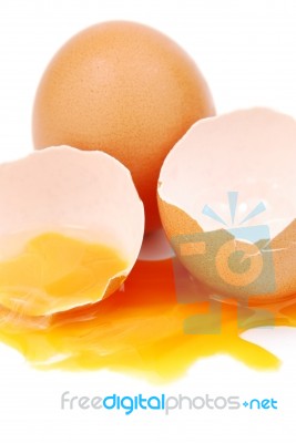 Broken Egg With The Yolk And White Oozing Out Stock Photo