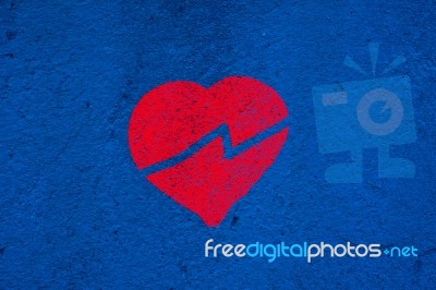 Broken Red Heart On Blue Wall Stock Image