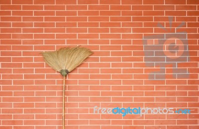 Broom Stick On Brick Wall Stock Photo