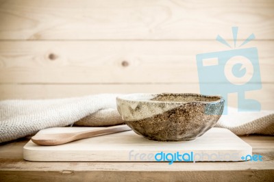 Brown Bowl With Spoon On Wooden Background Stock Photo