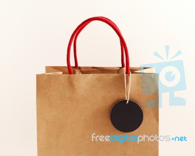 Brown Paper Bag With Black Tag Stock Photo