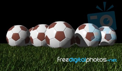 Brown Soccer Balls On A Green Grass Stock Image