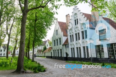 Bruges, Belgium - May 11, 2015: People Visit White Houses In The… Stock Photo