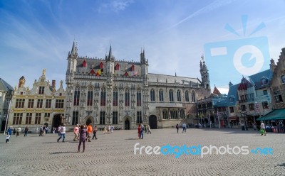 Bruges, Belgium - May 11, 2015: Tourist On Burg Square With City… Stock Photo