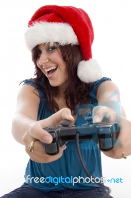 Brunette Female With Christmas Hat And Remote Stock Photo