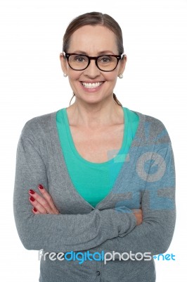 Brunette With Folded Arms Posing Cheerfully Stock Photo