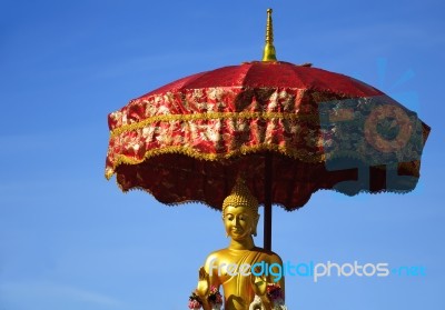 Buddha In The Red Umbrella Stock Photo