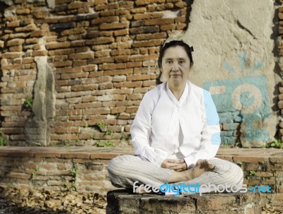 Buddhist Woman Meditating Stock Photo