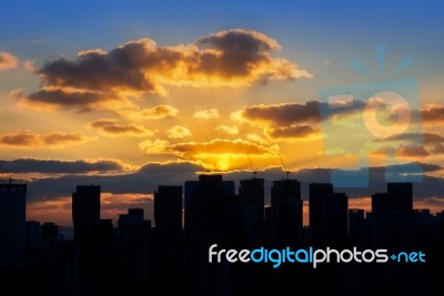 Building's Silhouettes Of A City And Sunset Stock Photo