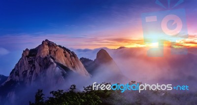 Bukhansan Mountains Is Covered By Morning Fog And Sunrise In Bukhansan National Park, Seoul In South Korea Stock Photo