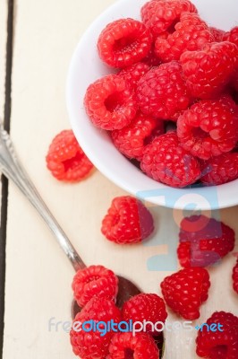 Bunch Of Fresh Raspberry On A Bowl And White Table Stock Photo