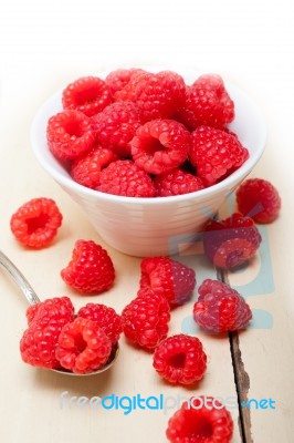 Bunch Of Fresh Raspberry On A Bowl And White Table Stock Photo