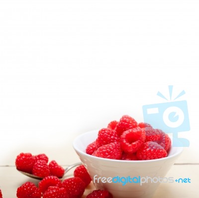 Bunch Of Fresh Raspberry On A Bowl And White Table Stock Photo