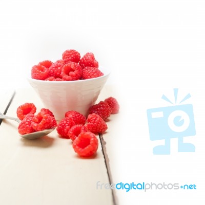 Bunch Of Fresh Raspberry On A Bowl And White Table Stock Photo