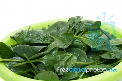 Bunch Of Fresh Spinach On A Green Bowl Stock Photo