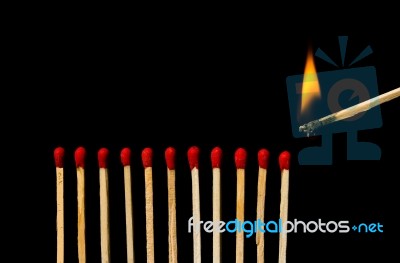 Burning Match With Row Of Matches Isolated On Black Background Stock Photo