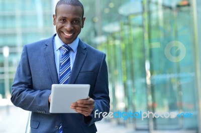 Busines Executive Smiling With Tablet Pc Stock Photo